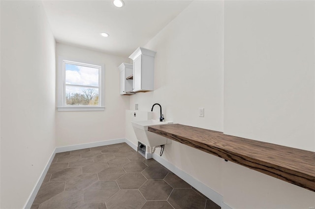 clothes washing area featuring tile patterned flooring, hookup for an electric dryer, and washer hookup