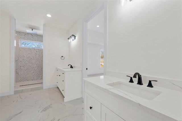 bathroom with vanity and tiled shower