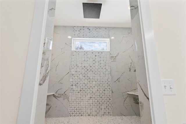 bathroom featuring a tile shower