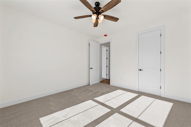 unfurnished bedroom featuring light carpet and ceiling fan