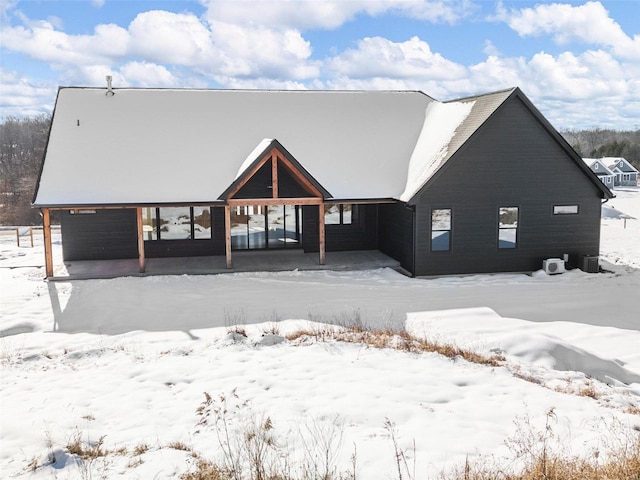 view of snow covered rear of property