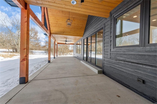 snow covered patio featuring ceiling fan