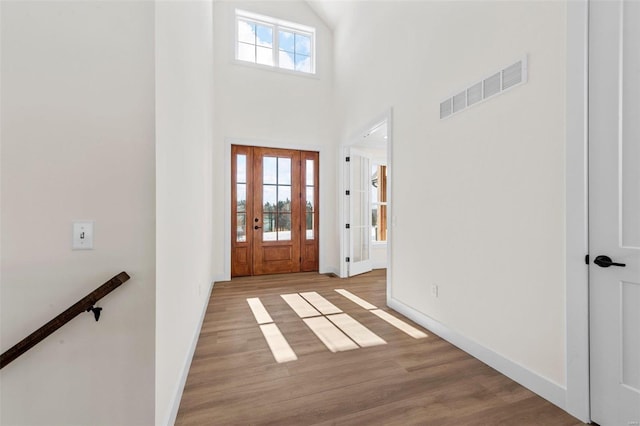 entryway featuring a high ceiling and light wood-type flooring