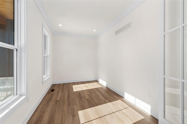 unfurnished room with hardwood / wood-style flooring and ornamental molding