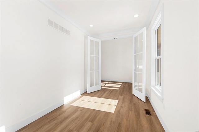 empty room featuring french doors and hardwood / wood-style floors