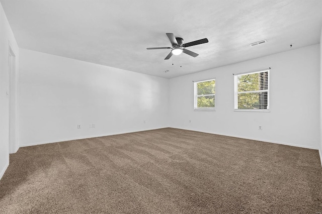 carpeted spare room with ceiling fan