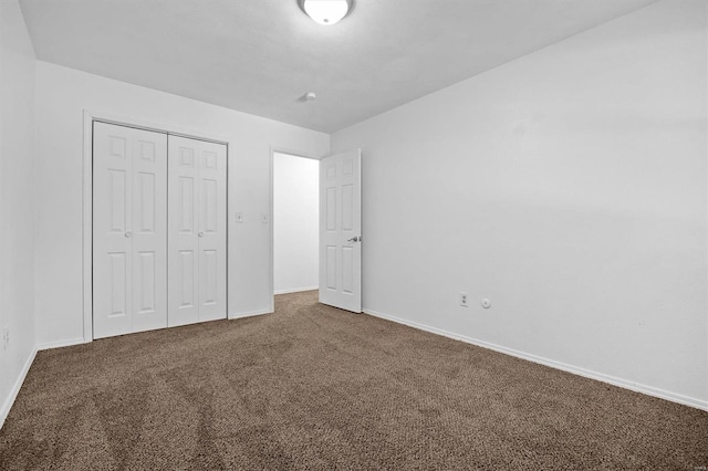 unfurnished bedroom with a closet and carpet