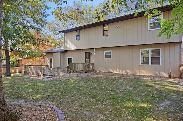 back of house featuring a yard and a deck