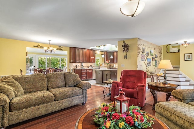 living room featuring dark hardwood / wood-style flooring and an inviting chandelier