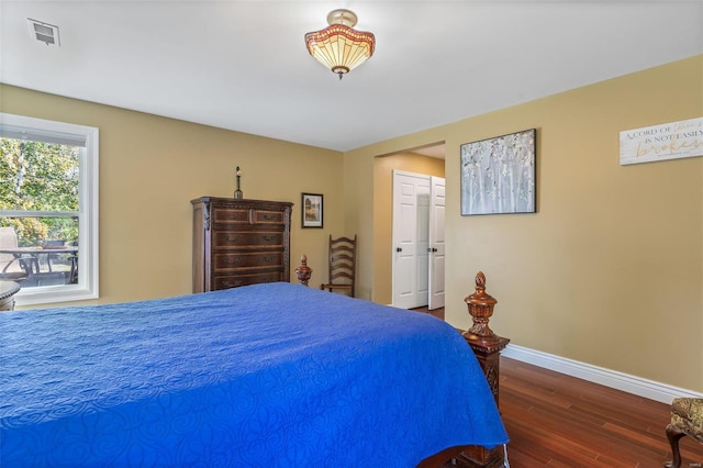 bedroom with dark hardwood / wood-style flooring