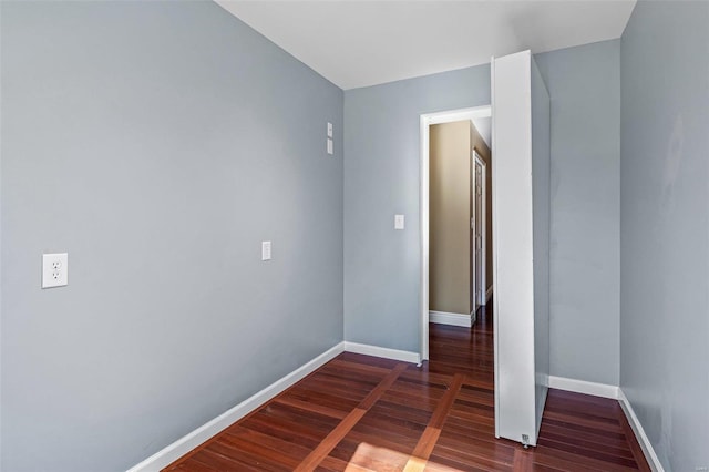 spare room featuring dark wood-type flooring