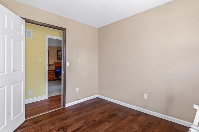 spare room featuring dark wood-type flooring