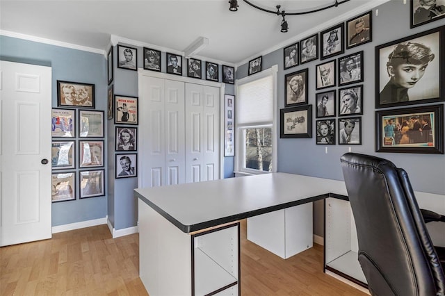 office area with crown molding and light hardwood / wood-style flooring