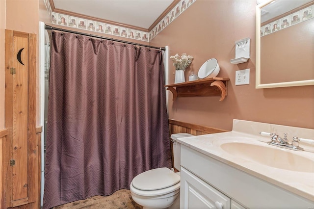 bathroom featuring vanity, toilet, and crown molding