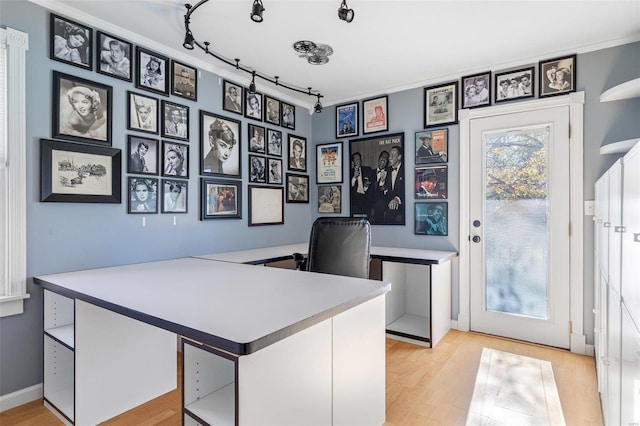 office space featuring light hardwood / wood-style floors and rail lighting