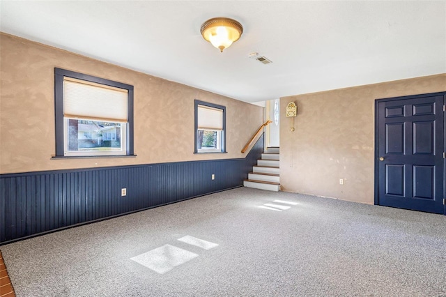 carpeted spare room with a healthy amount of sunlight