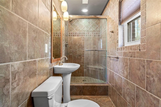 bathroom with an enclosed shower, tile walls, and toilet