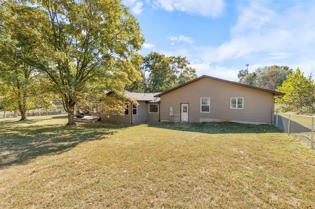 back of property featuring a yard