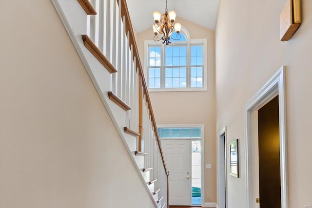 entrance foyer with a chandelier and high vaulted ceiling