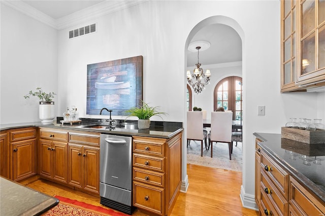 kitchen with an inviting chandelier, hanging light fixtures, ornamental molding, and sink