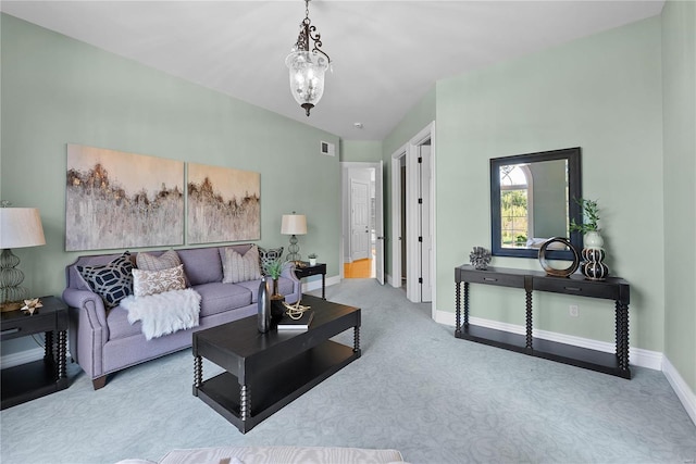 living room featuring light colored carpet and an inviting chandelier