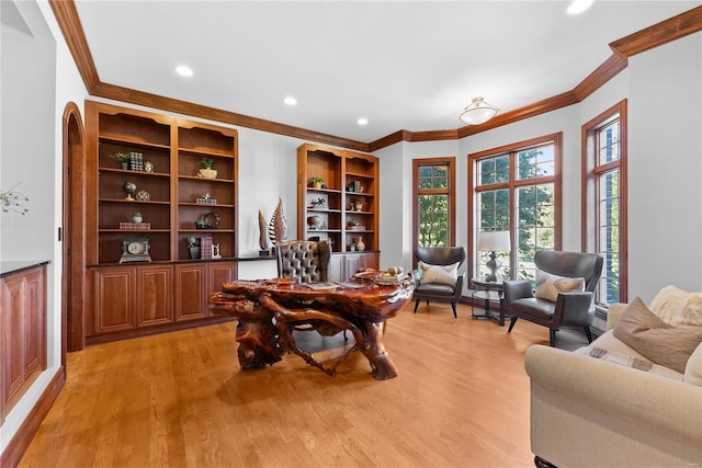 office space featuring light wood-type flooring and crown molding