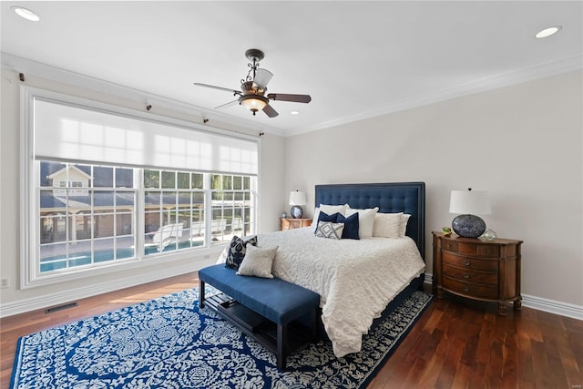 bedroom with ceiling fan, dark hardwood / wood-style floors, and crown molding