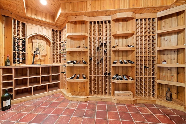 wine room with tile patterned floors and wooden ceiling