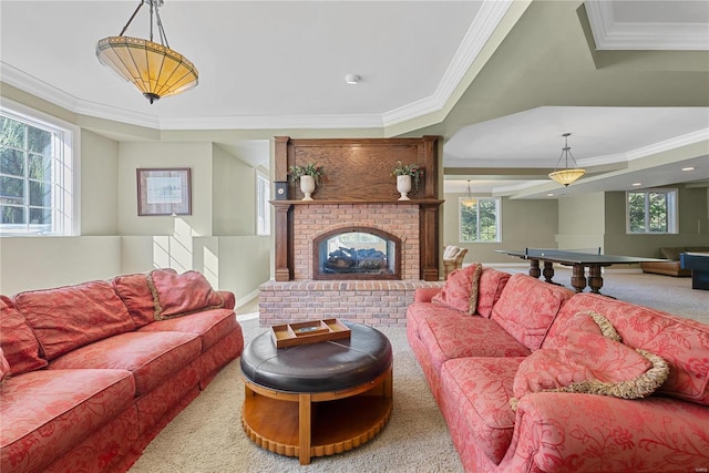 living room with carpet flooring, crown molding, and a brick fireplace