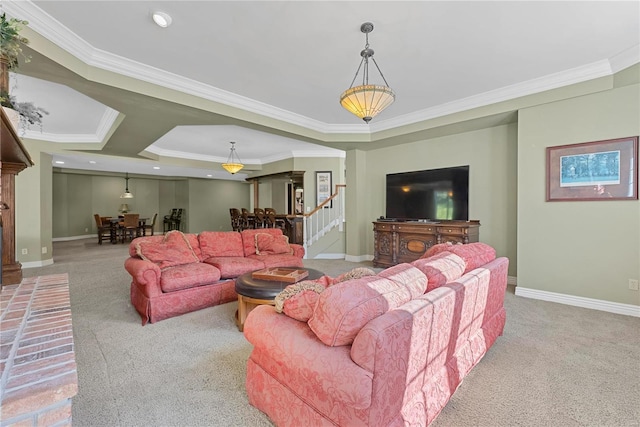 carpeted living room with a raised ceiling and crown molding