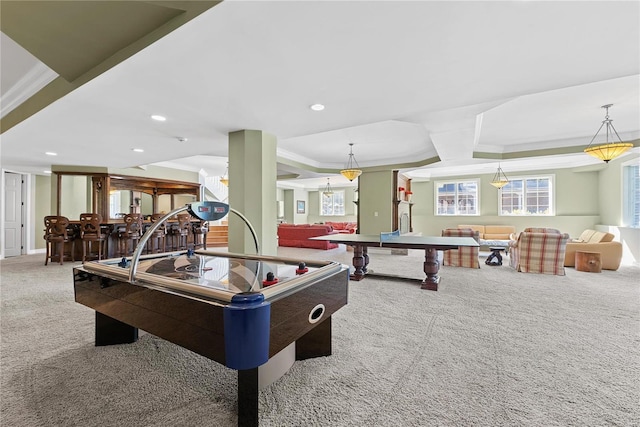 game room with carpet, a raised ceiling, crown molding, and indoor bar