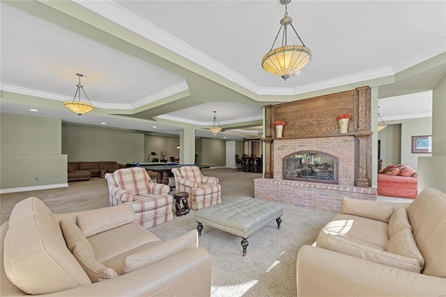 carpeted living room featuring a tray ceiling, crown molding, and a fireplace