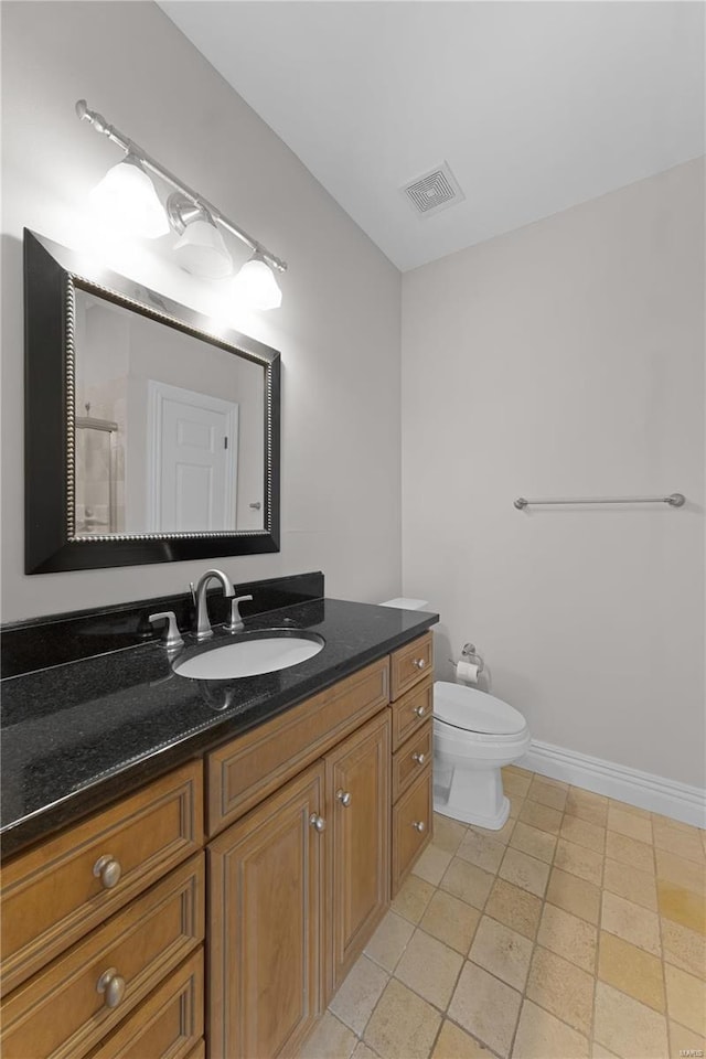 bathroom with tile patterned floors, vanity, toilet, and a shower with door