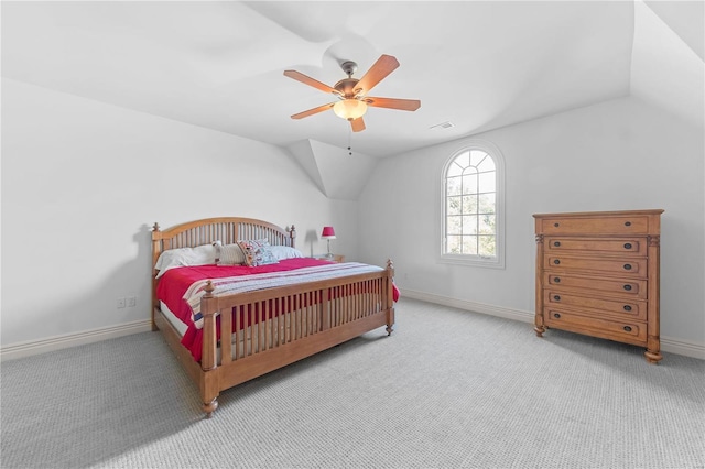 bedroom featuring light carpet, vaulted ceiling, and ceiling fan