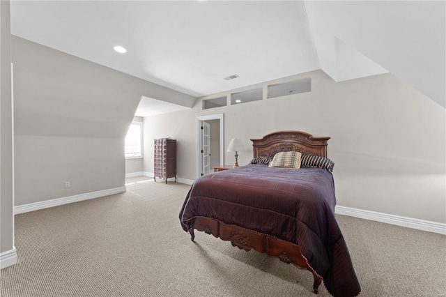 bedroom with light carpet and lofted ceiling