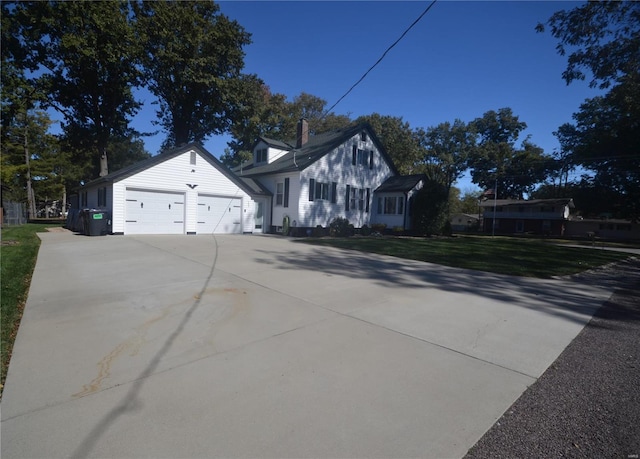 exterior space featuring a lawn and a garage