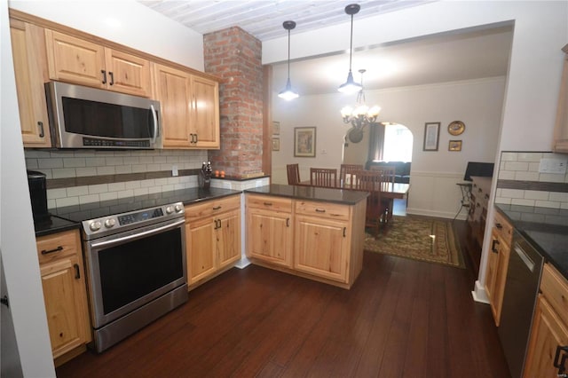 kitchen featuring kitchen peninsula, backsplash, appliances with stainless steel finishes, dark hardwood / wood-style floors, and ornate columns