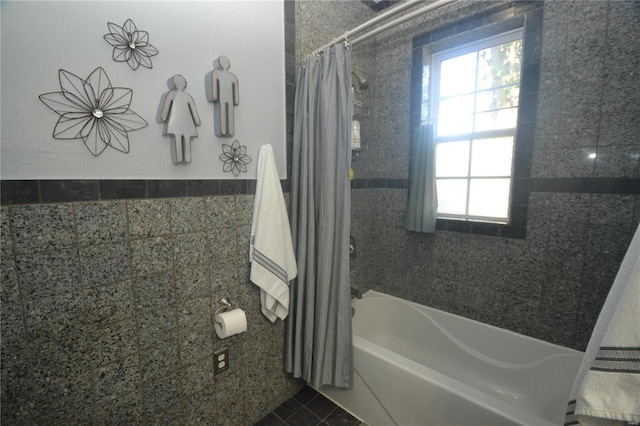 bathroom featuring shower / bath combo with shower curtain and tile patterned flooring