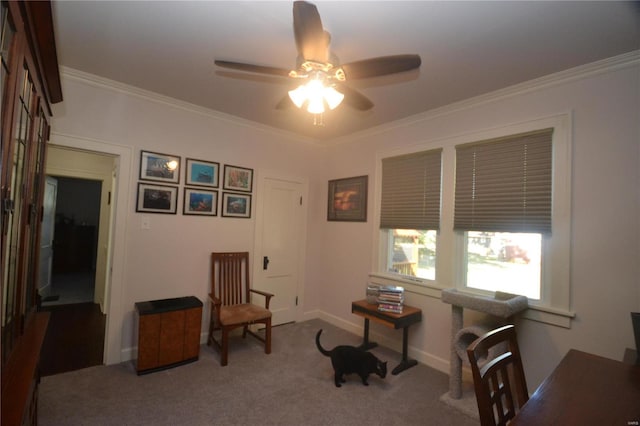 living area with crown molding, carpet flooring, and ceiling fan