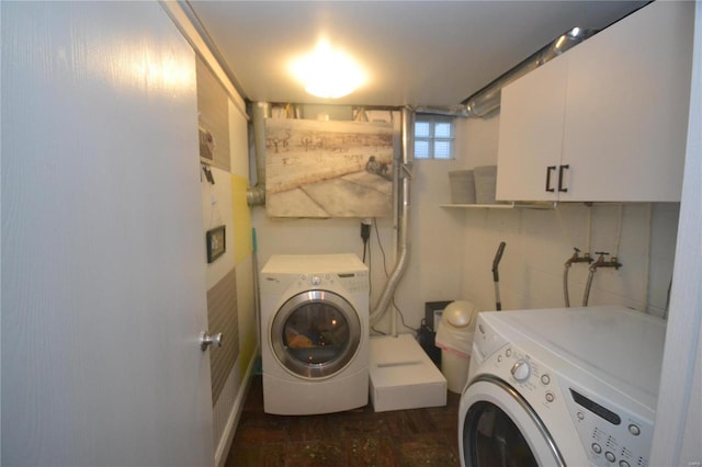 washroom with cabinets and washer and clothes dryer