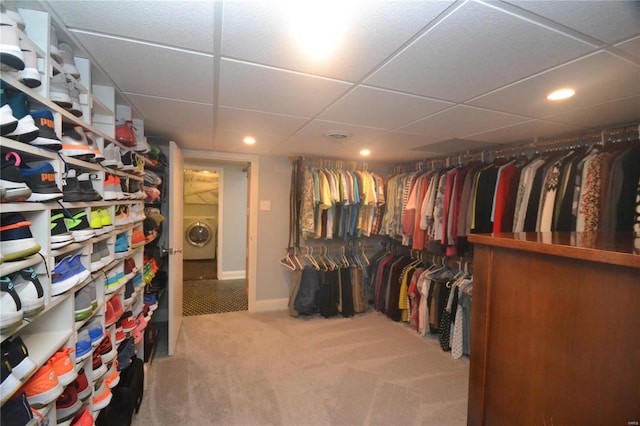 spacious closet with washer / clothes dryer, carpet floors, and a paneled ceiling