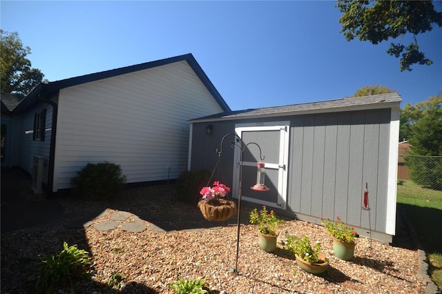 view of property exterior with a storage unit