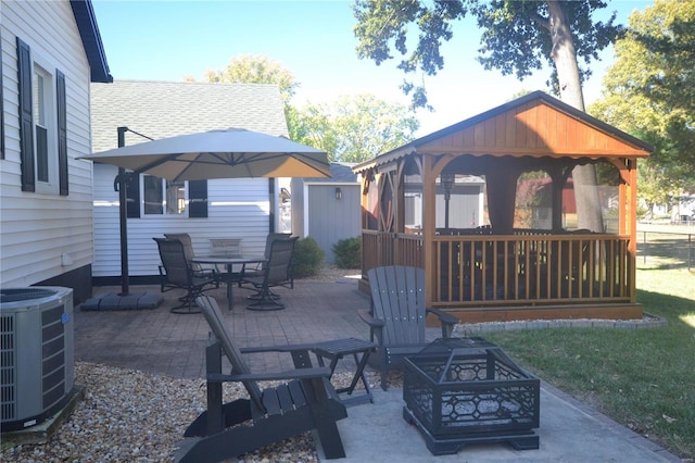 view of patio with a gazebo, a fire pit, and central AC unit