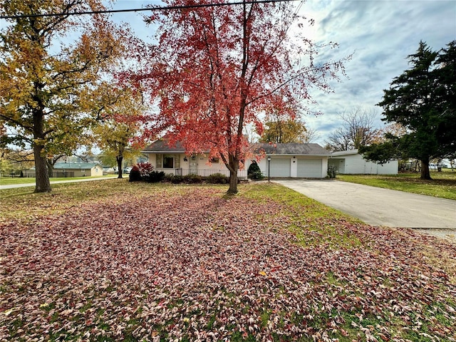 single story home with a garage and a front lawn