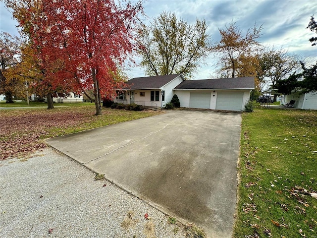 single story home with a garage and a front lawn