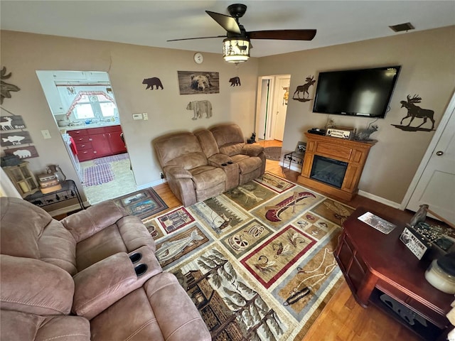 living room with hardwood / wood-style flooring and ceiling fan