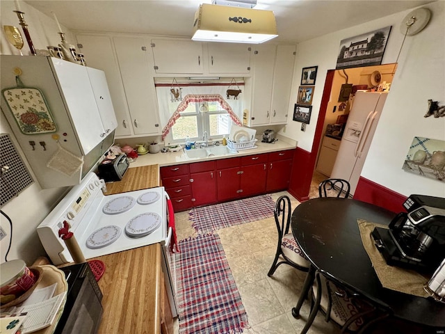 kitchen featuring white cabinets, white appliances, and sink