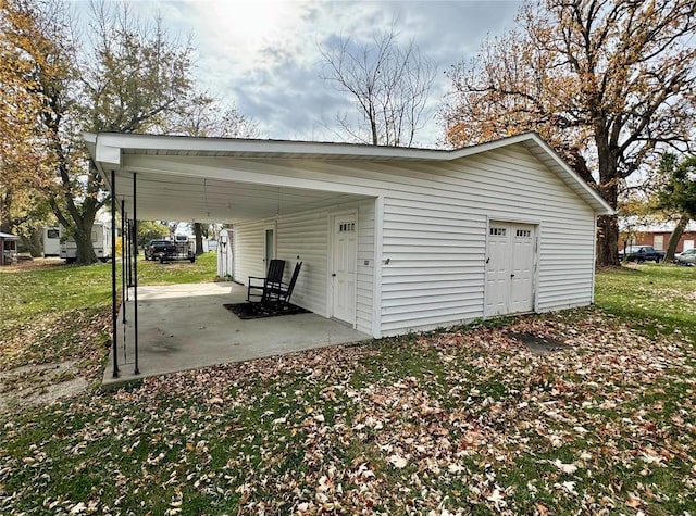 garage with a lawn and a carport