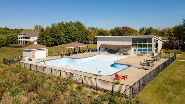 view of pool featuring a yard and a patio