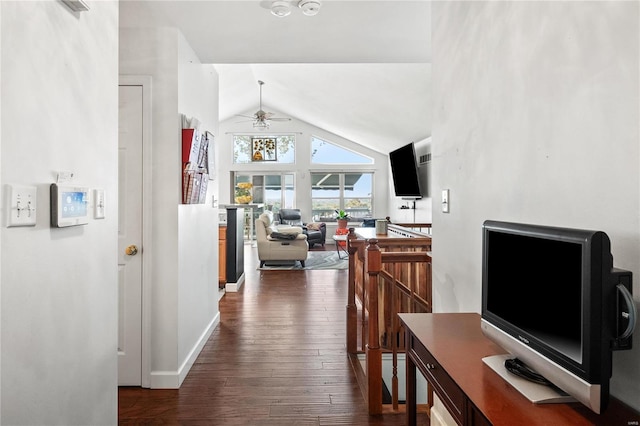 hallway with dark hardwood / wood-style floors and vaulted ceiling